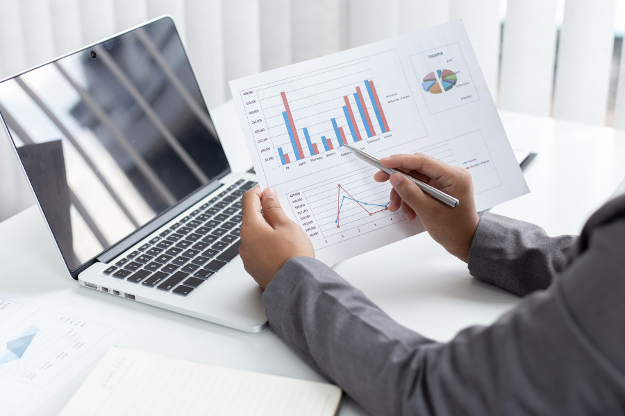 A corporate worker looking at financial data on paper