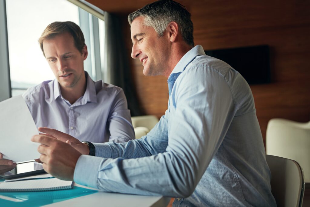 Accountant going through year-end figures with a small business owner at Phinch in Weston-super-Mare